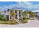 Aerial view of a two-story home with a white exterior, mature landscaping, and a circular driveway at 10009 Gasparilla Pass Blvd, Boca Grande, FL 33921