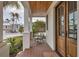 Charming porch with wooden ceiling and rocking chair, providing a relaxing outdoor space with views of lush greenery at 10009 Gasparilla Pass Blvd, Boca Grande, FL 33921