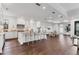 Bright kitchen with an island, white cabinets, and stainless steel appliances, open to the dining area at 10009 Gasparilla Pass Blvd, Boca Grande, FL 33921