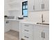 Laundry room features white cabinets, modern fixtures, and shelves at 10009 Gasparilla Pass Blvd, Boca Grande, FL 33921