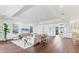 Open-concept living room with hardwood floors, leading to the dining area and a home office at 10009 Gasparilla Pass Blvd, Boca Grande, FL 33921