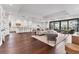 Open-concept living space with hardwood floors, modern furniture, and access to an outdoor balcony at 10009 Gasparilla Pass Blvd, Boca Grande, FL 33921