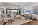 Bright living room featuring hardwood floors, elegant furniture, and sliding doors to the outdoor area at 10009 Gasparilla Pass Blvd, Boca Grande, FL 33921