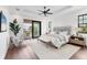 Serene main bedroom with a king-size bed, balcony access, neutral decor, and plenty of natural light, offering a tranquil retreat at 10009 Gasparilla Pass Blvd, Boca Grande, FL 33921