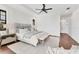 This cozy main bedroom features wood floors, a tray ceiling, and neutral colors at 10009 Gasparilla Pass Blvd, Boca Grande, FL 33921