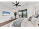 Cozy main bedroom featuring a king-sized bed, tray ceilings, balcony access, and neutral decor, offering a peaceful retreat at 10009 Gasparilla Pass Blvd, Boca Grande, FL 33921