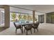 Spacious covered patio with dining set and view of the sparkling pool and well-manicured yard at 10009 Gasparilla Pass Blvd, Boca Grande, FL 33921