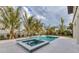 The backyard features a pool and hot tub with well-maintained landscaping with trees to enhance the privacy of the property at 10009 Gasparilla Pass Blvd, Boca Grande, FL 33921