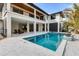 An outdoor pool and patio area offers an inviting space for relaxation and entertainment in the backyard at 10009 Gasparilla Pass Blvd, Boca Grande, FL 33921