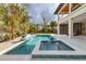 Backyard pool and spa with lush landscaping and an outdoor living space perfect for entertaining at 10009 Gasparilla Pass Blvd, Boca Grande, FL 33921