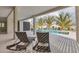 A view of the pool and lounge chairs on the patio of this house with tropical foliage nearby at 10009 Gasparilla Pass Blvd, Boca Grande, FL 33921