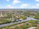 Aerial view of waterfront community with houses and canals at 10424 Rainsville St, Port Charlotte, FL 33981