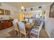 Bright dining room with a wooden table and white chairs at 101 Normandy Way # 103, Rotonda West, FL 33947