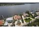 Aerial view of waterfront home with private dock and lush landscaping at 8035 Manasota Key Rd, Englewood, FL 34223