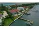 Stunning aerial showcasing waterfront home, private dock, and ocean views at sunset at 8035 Manasota Key Rd, Englewood, FL 34223