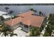 Waterfront home with terracotta roof and attached garage, offering stunning views at 8035 Manasota Key Rd, Englewood, FL 34223