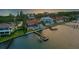 Waterfront property aerial view, showcasing a private dock and beautiful sunset at 8035 Manasota Key Rd, Englewood, FL 34223