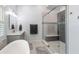 Elegant bathroom with soaking tub, walk-in shower, and modern vanity at 8035 Manasota Key Rd, Englewood, FL 34223
