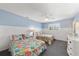 Guest bedroom with two twin beds and floral bedding at 8035 Manasota Key Rd, Englewood, FL 34223