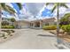 Mediterranean style home with palm trees at 8035 Manasota Key Rd, Englewood, FL 34223