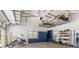 Spacious garage with overhead storage, shelving, and ample floor space at 8035 Manasota Key Rd, Englewood, FL 34223