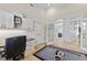 Home office with built-in cabinetry and view of kitchen at 8035 Manasota Key Rd, Englewood, FL 34223