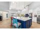 Bright kitchen with white cabinets, blue island, and water views at 8035 Manasota Key Rd, Englewood, FL 34223