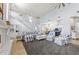 High-ceilinged living room with a cozy seating area and a view of the kitchen at 8035 Manasota Key Rd, Englewood, FL 34223