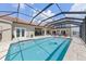 Large screened-in pool with a tiled design and waterfront view at 8035 Manasota Key Rd, Englewood, FL 34223