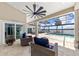 Relaxing screened-in pool area with patio furniture and waterfront view at 8035 Manasota Key Rd, Englewood, FL 34223