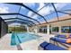 Luxury screened-in pool and patio with stunning water views at 8035 Manasota Key Rd, Englewood, FL 34223
