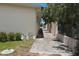 Side yard with paved walkway and landscaping at 8035 Manasota Key Rd, Englewood, FL 34223
