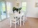 White table and chairs in dining area with view to backyard at 133 Wahoo Dr, Rotonda West, FL 33947