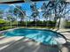 Inviting kidney-shaped pool with screened enclosure at 133 Wahoo Dr, Rotonda West, FL 33947