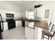 Modern kitchen featuring granite counters and white cabinets at 133 Wahoo Dr, Rotonda West, FL 33947