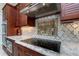 Luxury kitchen with granite countertops and a mosaic backsplash at 8074 Wiltshire Dr, Port Charlotte, FL 33981