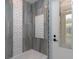 Bathroom with grey marble tile, decorative inserts and a tub at 8074 Wiltshire Dr, Port Charlotte, FL 33981