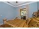 Bedroom with gold bedding and access to the outside patio at 8074 Wiltshire Dr, Port Charlotte, FL 33981