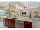 Kitchen island with granite countertop, sink, and wine cooler at 8074 Wiltshire Dr, Port Charlotte, FL 33981