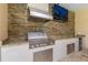 Stainless steel outdoor kitchen with granite countertops and built-in grill at 8074 Wiltshire Dr, Port Charlotte, FL 33981