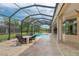 Screened pool and patio with seating area at 8074 Wiltshire Dr, Port Charlotte, FL 33981