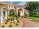 Inviting entryway with walkway, landscaping, and a double door entry at 8074 Wiltshire Dr, Port Charlotte, FL 33981