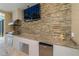 Outdoor kitchen featuring a granite countertop, stainless steel appliances, and stone backsplash at 8074 Wiltshire Dr, Port Charlotte, FL 33981