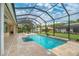 Inviting screened pool with travertine decking at 8074 Wiltshire Dr, Port Charlotte, FL 33981