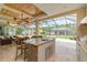 Outdoor kitchen with granite countertop and built-in appliances at 8074 Wiltshire Dr, Port Charlotte, FL 33981
