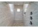 Spacious shower with marble tile and built-in seat at 8074 Wiltshire Dr, Port Charlotte, FL 33981