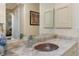 Elegant bathroom sink with a unique glass bowl and granite countertop at 8074 Wiltshire Dr, Port Charlotte, FL 33981