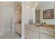 Double vanity bathroom with beige cabinets and patterned flooring at 8074 Wiltshire Dr, Port Charlotte, FL 33981