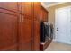 Laundry room with wood cabinets and modern appliances at 8074 Wiltshire Dr, Port Charlotte, FL 33981