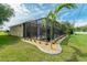 Screened pool and patio area with lush landscaping at 8074 Wiltshire Dr, Port Charlotte, FL 33981